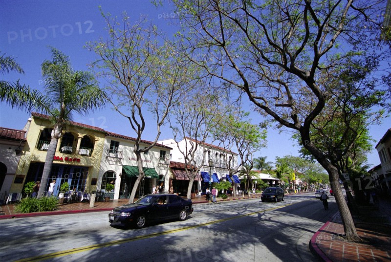 USA, California, Santa Barbara, View along State Street with shops and cafes and passing cars