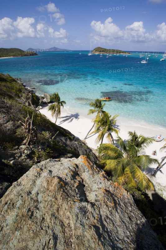 WEST INDIES, St Vincent & The Grenadines, Tobago Cays, View over the beach of Jamesby Island and moored yachts towards Canouan on the horizon