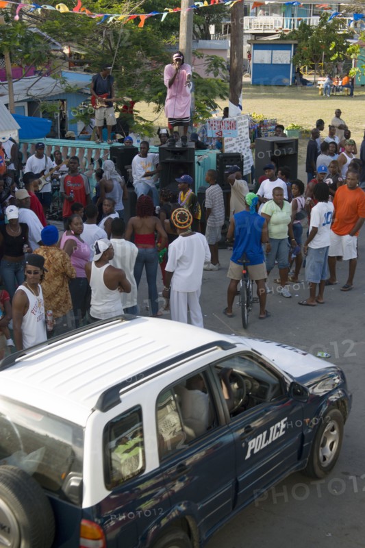WEST INDIES, St Vincent & The Grenadines, Union Island, Singer singing to and about police at Easterval Easter Carnival in Clifton