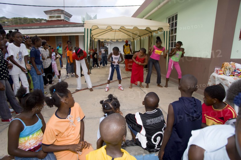 WEST INDIES, St Vincent & The Grenadines, Union Island, Children watching other children dancing to a sound system at the Easterval Easter Carnival in Clifton