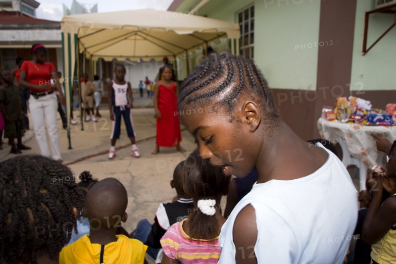 WEST INDIES, St Vincent & The Grenadines, Union Island, Children watching other children dancing to a sound system at the Easterval Easter Carnival in Clifton