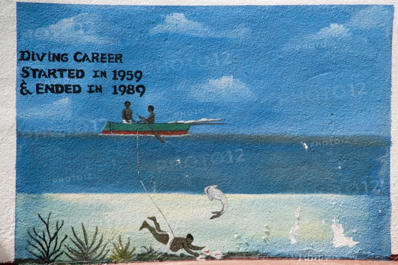 WEST INDIES, St Vincent & The Grenadines, Union Island, Wall painting in Clifton depicting the short lifespan of a conch shell diver