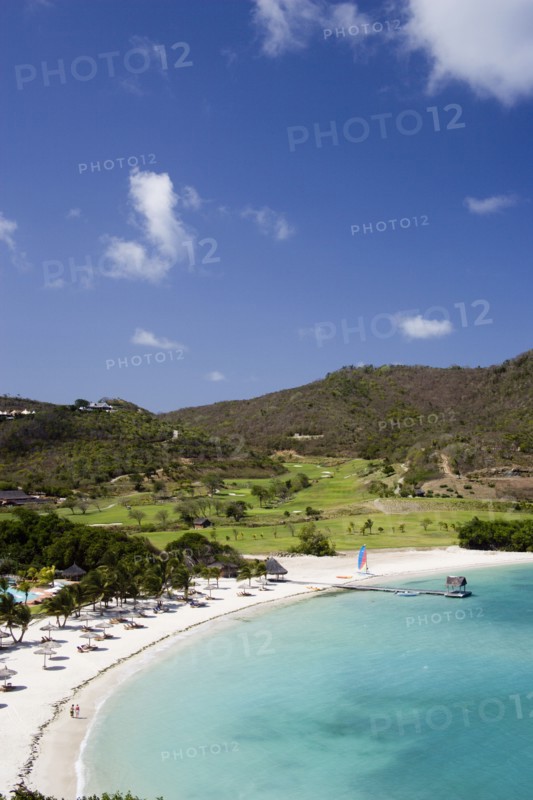 WEST INDIES, St Vincent & The Grenadines, Canouan, Jambu Beach in Carenage Bay at Raffles Resort with the Trump International Golf Course behind
