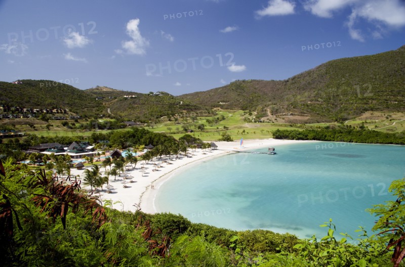 WEST INDIES, St Vincent & The Grenadines, Canouan, Jambu Beach in Carenage Bay at Raffles Resort with the Trump International Golf Course behind