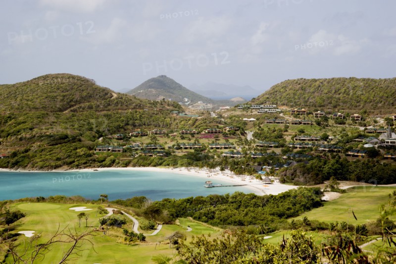 WEST INDIES, St Vincent & The Grenadines, Canouan, Jambu Beach at Raffles Resort and the Trump International Golf Course with Union Island in the distance