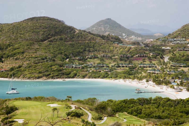 WEST INDIES, St Vincent & The Grenadines, Canouan, Jambu Beach at Raffles Resort and Trump International Golf Course with Union Island in the distance