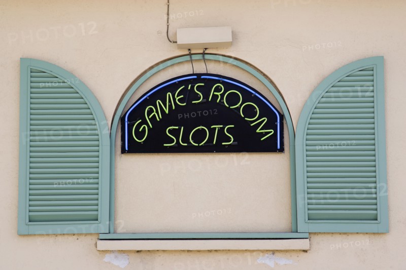 WEST INDIES, Barbados, St James, Gambling rooms neon sign in faked window promoting Slots in Holetown