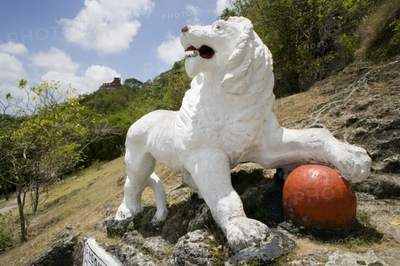 WEST INDIES, Barbados, St George, Imperial lion carved from coral rock by British soldiers serving at Gun Hill signal station with the station on the hill in the distance