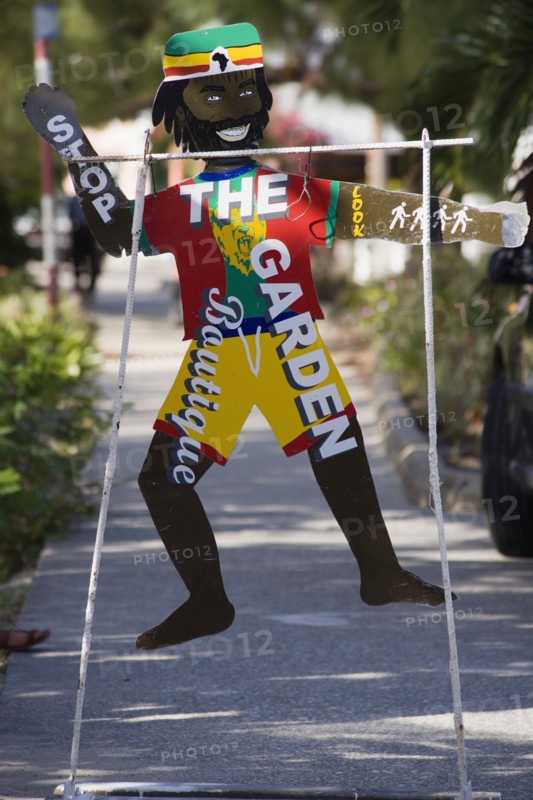 WEST INDIES, St Vincent & The Grenadines, Bequia, Colourful sign for clothes shop on Belmont Walkway in Port Elizabeth
