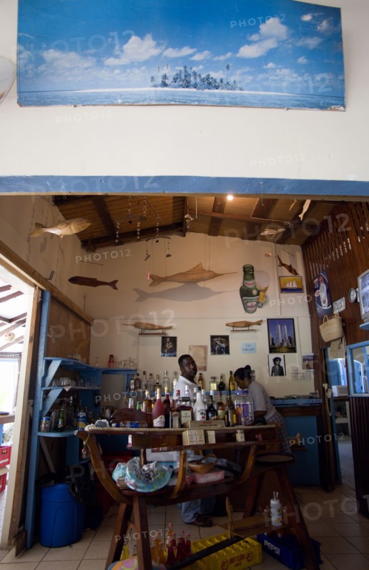 WEST INDIES, St Vincent & The Grenadines, Bequia, Bar and staff at beachside restaurant on Lower Bay