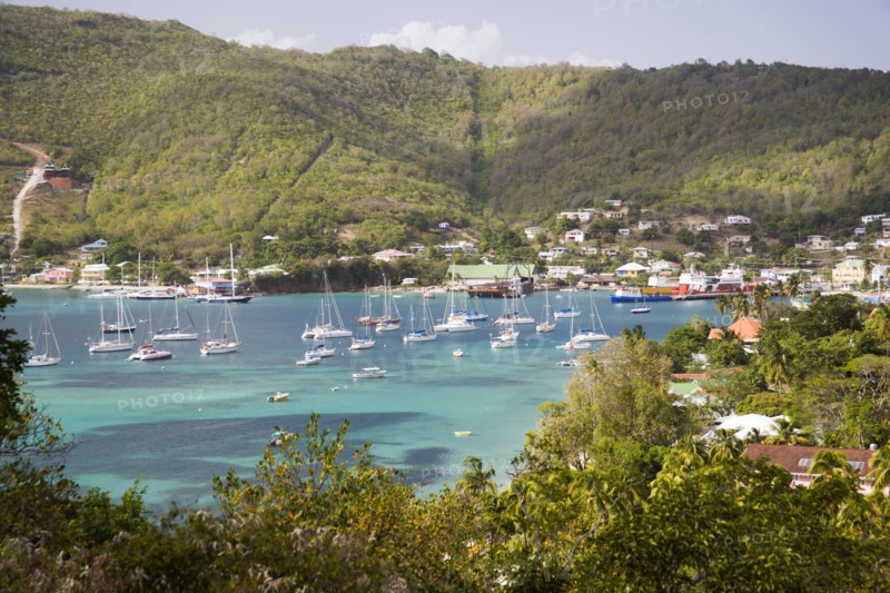 WEST INDIES, St Vincent & The Grenadines, Bequia, Port Elizabeth in Admiralty Bay with moored yachts and hillside houses