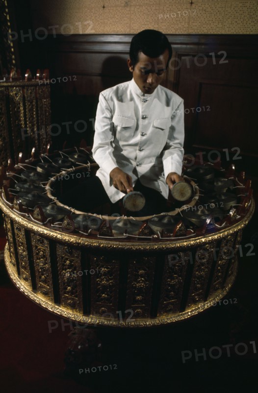 THAILAND, Bangkok, Musician playing Burmese circular drum at School of Music and Dance.