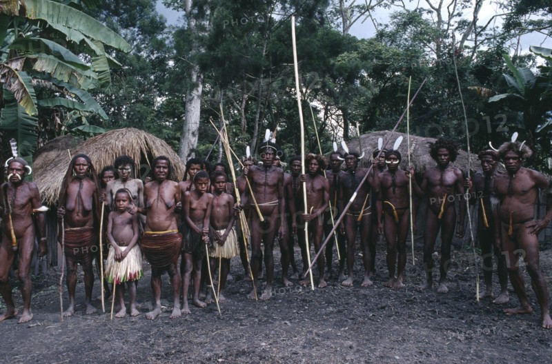 INDONESIA, Irian Jaya, Baliem Valley, Dani villagers preparing for a mock battle.