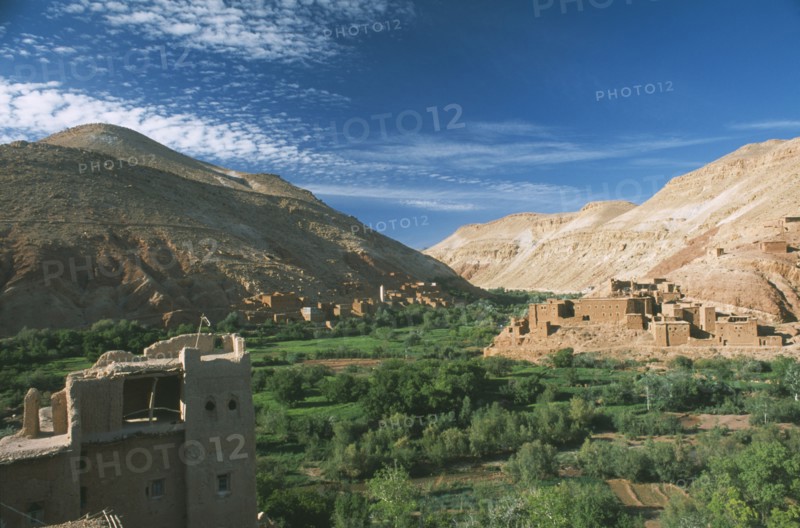 MOROCCO, High Atlas Mountains, Tioughassine, Kasbah and village overlooking fertile valley.
