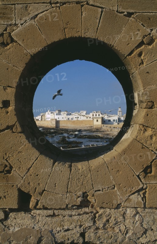 MOROCCO, Essaouira, Fortified coastal town framed in circular opening in wall.