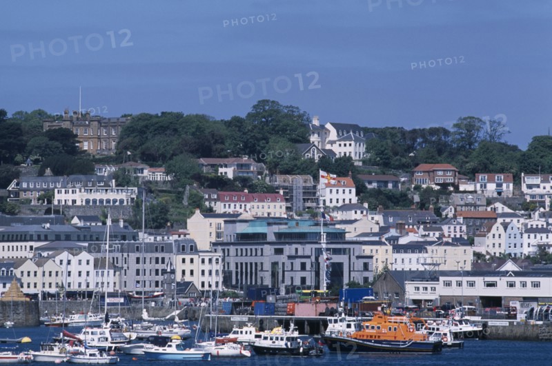 UNITED KINGDOM, Channel Islands, Guernsey, St Peter Port. Boats and quayside buldings.