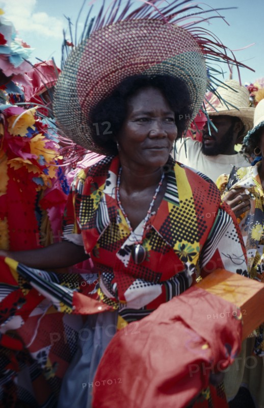 HAITI, People, Three-quarter portrait of woman at a Ra Ra procession wearing wide brimmed straw hat