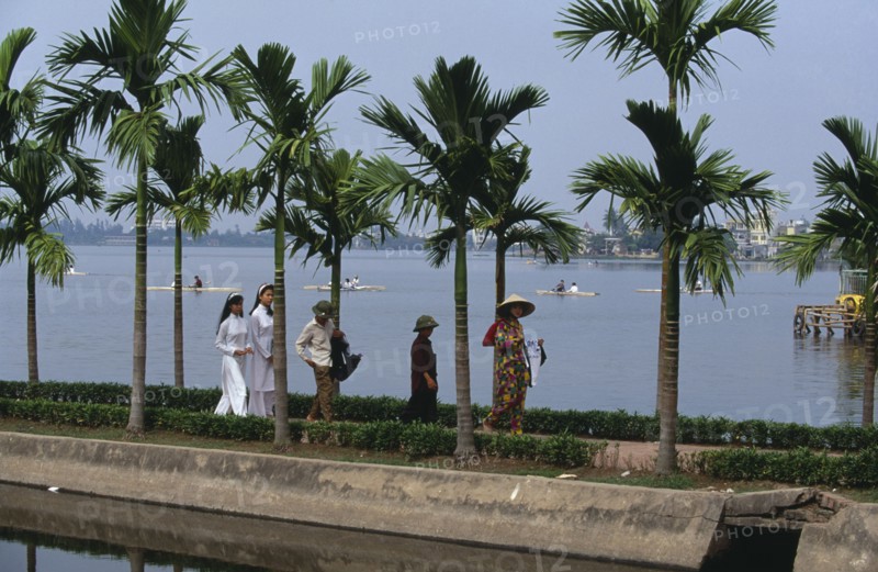 VIETNAM, North, Hanoi, People on the causeway to Tran Quoc Pagoda beside West Lake in popular recreational area north west of the city.