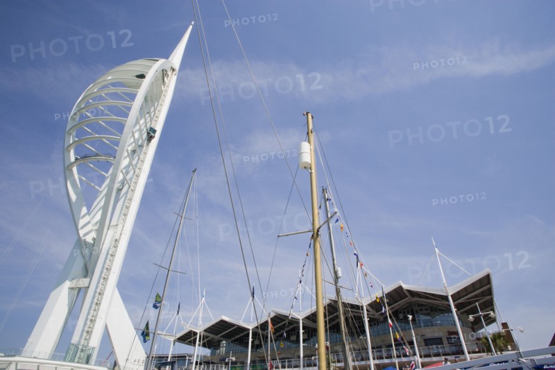 ENGLAND, Hampshire, Portsmouth, The Spinnaker Tower the tallest public viewing platforn in the UK at 170 metres on Gunwharf Quay with yachts mast in the foreground and waterfront attractions behind