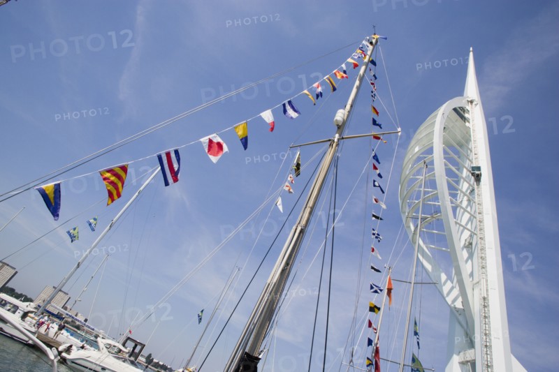 ENGLAND, Hampshire, Portsmouth, The Spinnaker Tower the tallest public viewing platforn in the UK at 170 metres on Gunwharf Quay with flag decorated yachts mast in the foreground