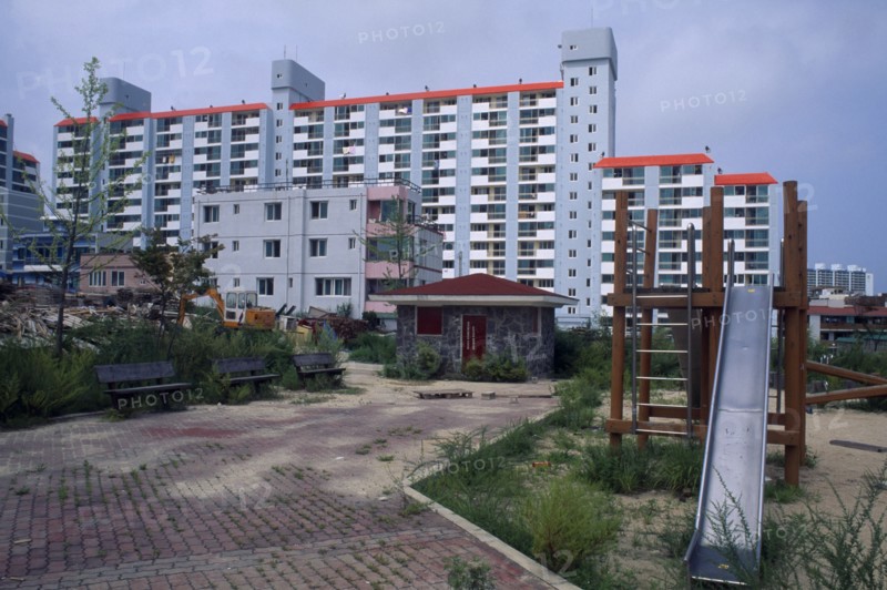 SOUTH KOREA, Sokcho, Large apartment block and childrens playground in east coast fishing port.