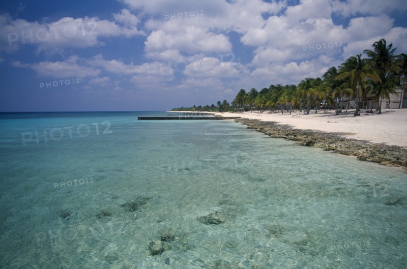CUBA, Pinar del Rio, Maria la Gorda, "Narrow stretch of empty sandy beach fringed with palm trees beside clear, sparkling water."