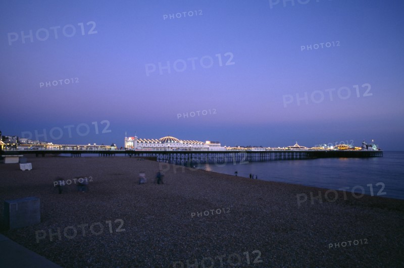 ENGLAND, East Sussex, Brighton, Brighton Pier illuminated in evening light.