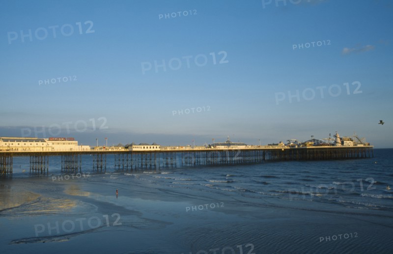 ENGLAND, East Sussex, Brighton, Brighton Pier in early evening light.