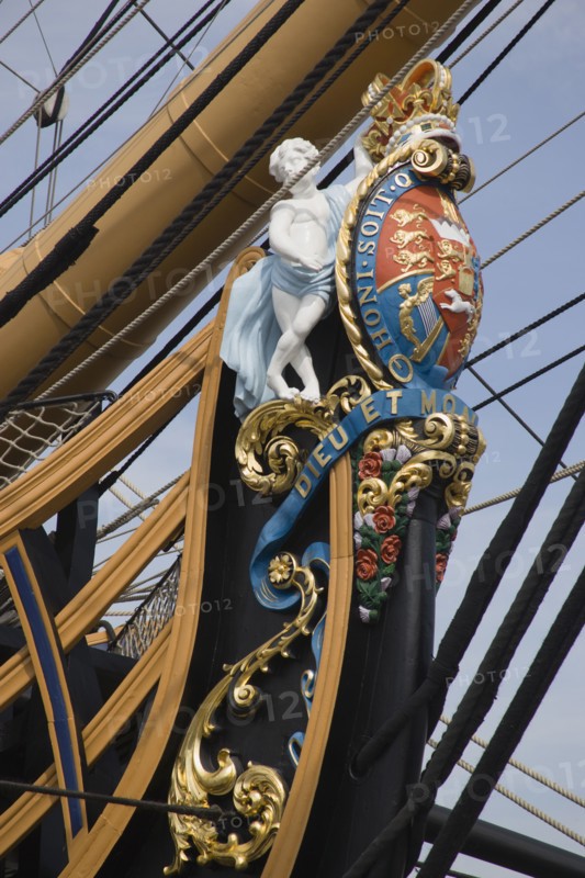 ENGLAND, Hampshire, Portsmouth, The bow of HMS Victory in the Historic Dockyard showing the bow figurehead with Royal crest.