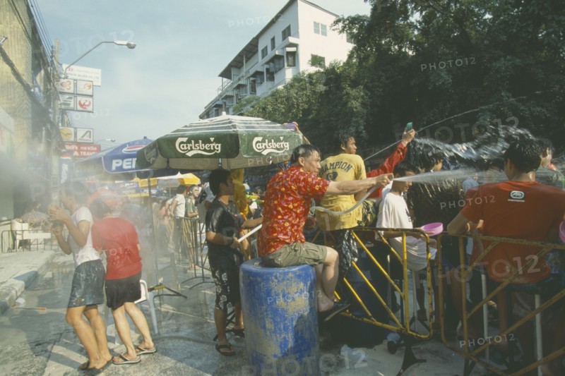 THAILAND, Bangkok, "Crowd having a water fight, celebrating the Songkhran Festival. Thai New Year, 15 April."