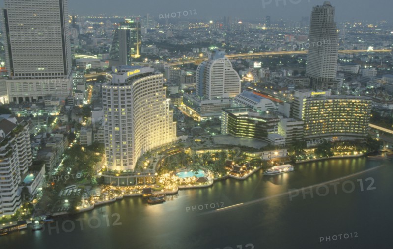 THAILAND, Bangkok, Aerial view of the Skyline. Large Hotel with swimming pool and boats next to the Chaophraya River