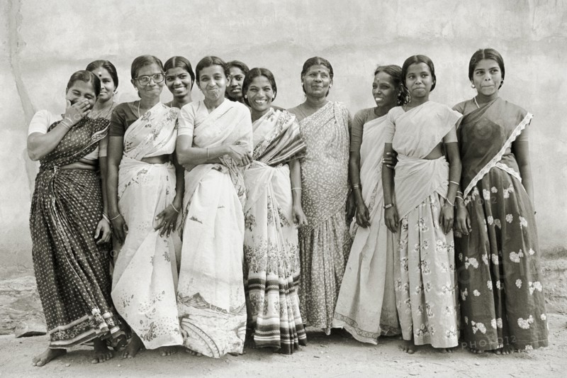 INDIA, Tamil Nadu, Vellamadam, Female workers at St. Joseph's Orphanage smile and laugh for the camera.
