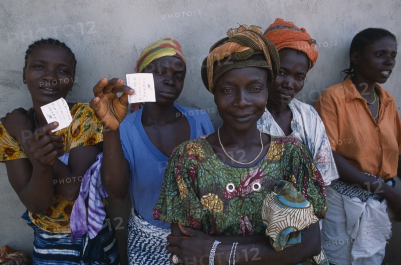 GUINEA, People, Women, Sierra Leonean refugees queuing for food rations at Kissidougou camp.