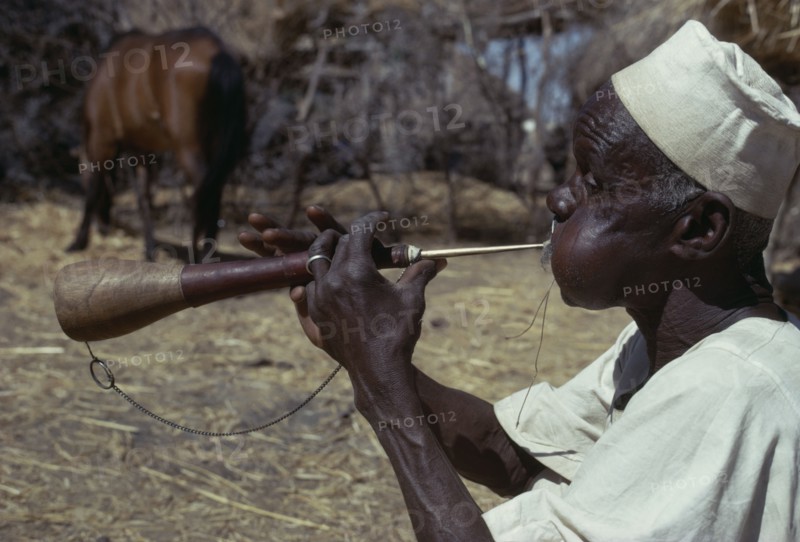 CHAD, Music, "Musician playing a shawm, a traditional double reed instrument"