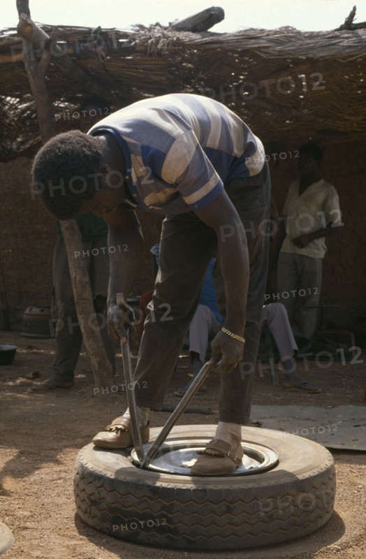 IVORY COAST, Transport, Man mending tyre puncture