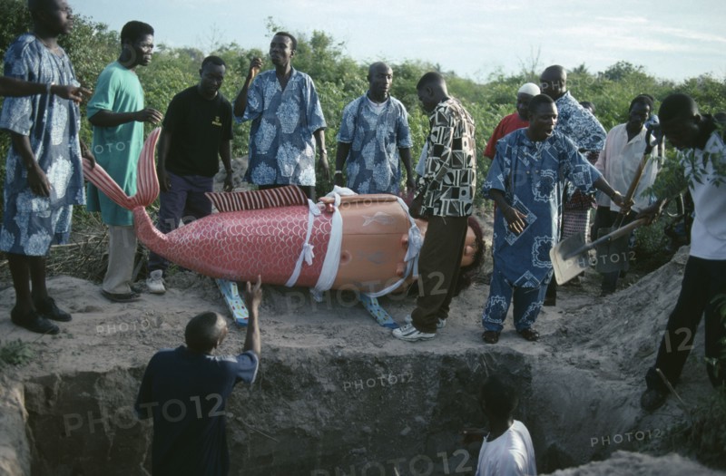 GHANA, South, Teshie, Burial of Ga tribal priestess of the sea god Kanjar in coffin made and painted to represent a mermaid following tradition of decorating coffin to reflect life of the deceased.
