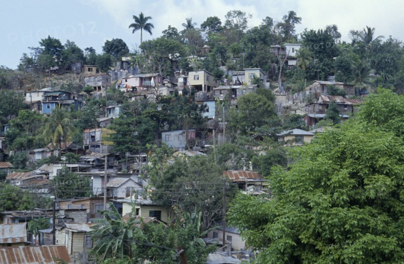 JAMAICA, Montego Bay, Norwood, "Overcrowded slum area, shanty housing on hillside with corrugated tin rooves."