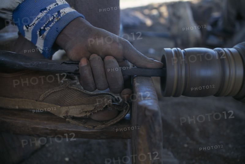 MALAWI, Zalewa, Kadzuwa Crafts.  Cropped view of craftsman using wood turner to produce fair trade carved items for export.