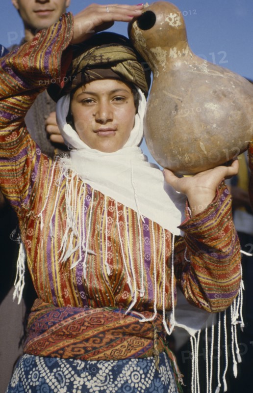 TURKEY, East, Young woman carrying calabash gourd for water.