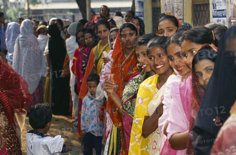 BANGLADESH, Dhaka, Crowd of women waiting in line at polling station to vote in local elections.