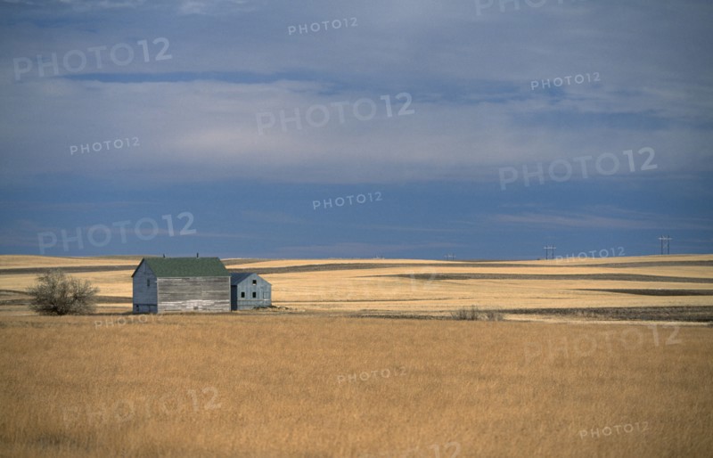 USA, North Dakota, Vast expanse of prairie and distant farm building