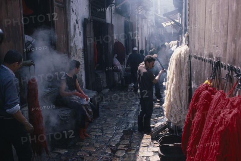 MOROCCO, Fez, Street scene in area of wool dyers with skeins of coloured wool hanging up to dry.