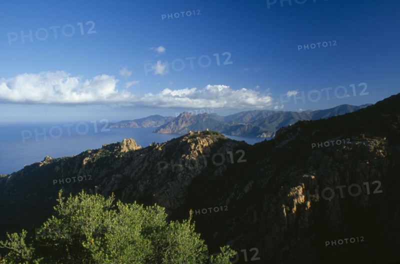 FRANCE, Corsica, "The Calanches in the city of Piana catch the first morning light, with the Scandola peninsula in the distance."