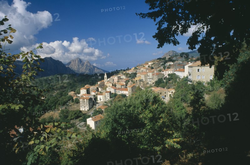 FRANCE, Corsica, "Morning in the hillside village of Evisa, with cumulus clouds crowning Capo D’Orto in the distance."
