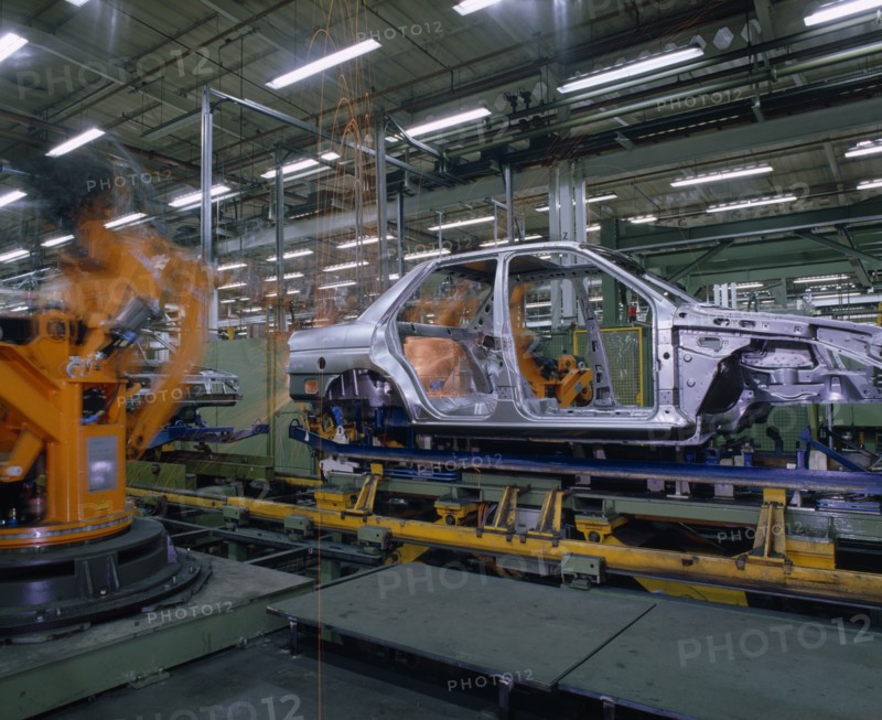 INDUSTRY, Cars, Ford Orion Car Production. Interior of factory with the shell of a silver car on production line.
