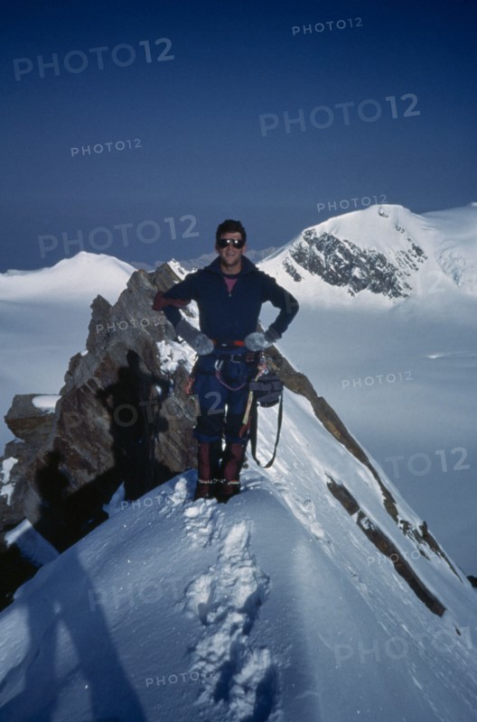 INDIA, Himalayas, Climber on snow covered summit.