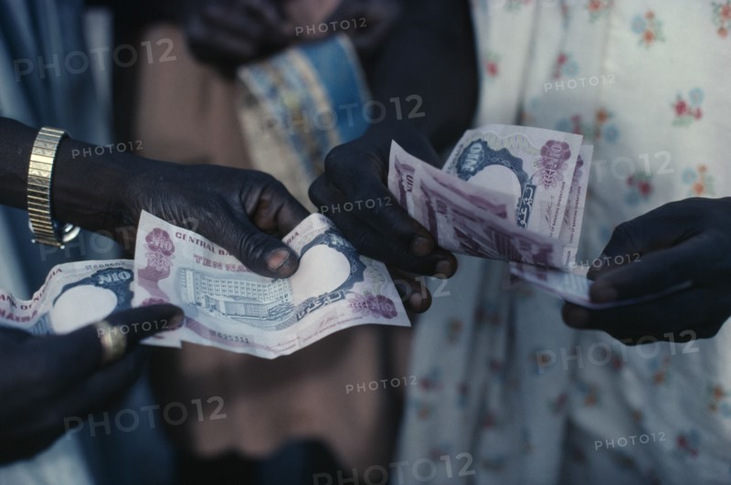 NIGERIA, Money, Cropped shot of money changing hands.
