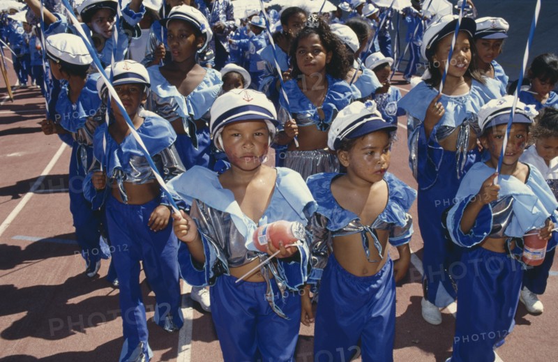 SOUTH AFRICA, Western Cape, Cape Town, Children in costumes and face paint taking part in Cape Coon New Year carnival parade at Green Point Stadium.