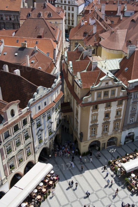 CZECH REPUBLIC, Bohemia, Prague, Restaurant and cafe tables with strolling pedestrians in the Old Town Square