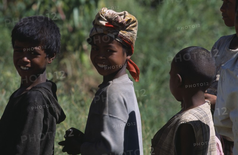 MADAGASCAR, People, Children , Portrait of a girl wearing a headscarf standing amongst two other children